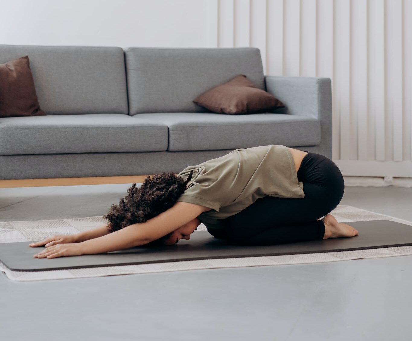 Woman in Brown Shirt In A Bending Position